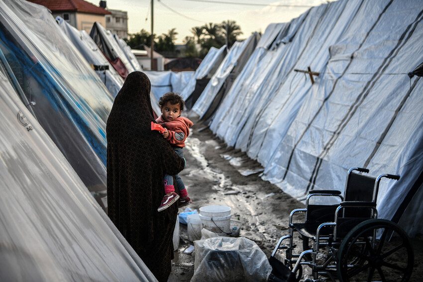 Mother and child amid the tents in Rafah, southern Gaza.